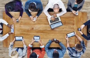 Group of business people using digital devices