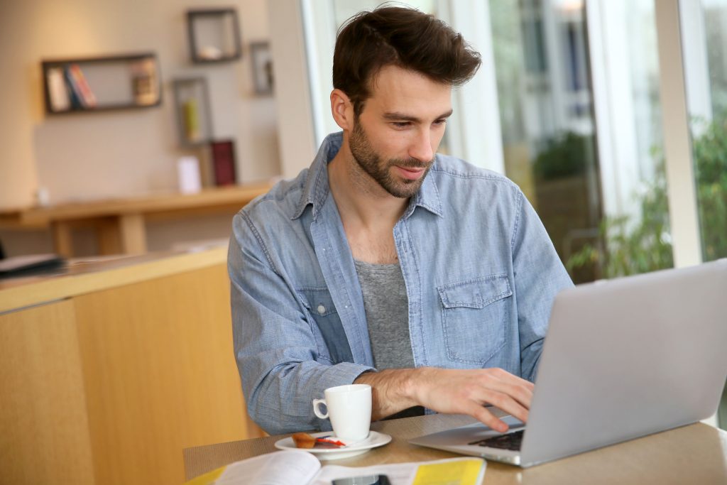 Man working on laptop computer from home