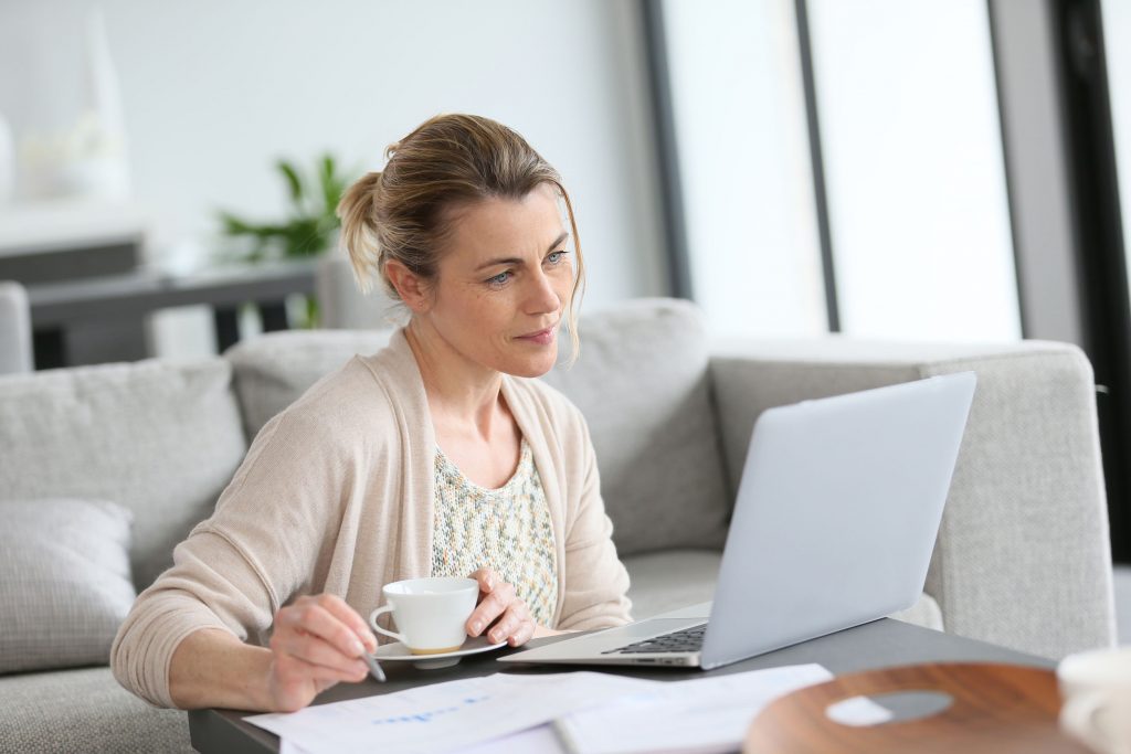 Middle-aged woman working from home on laptop