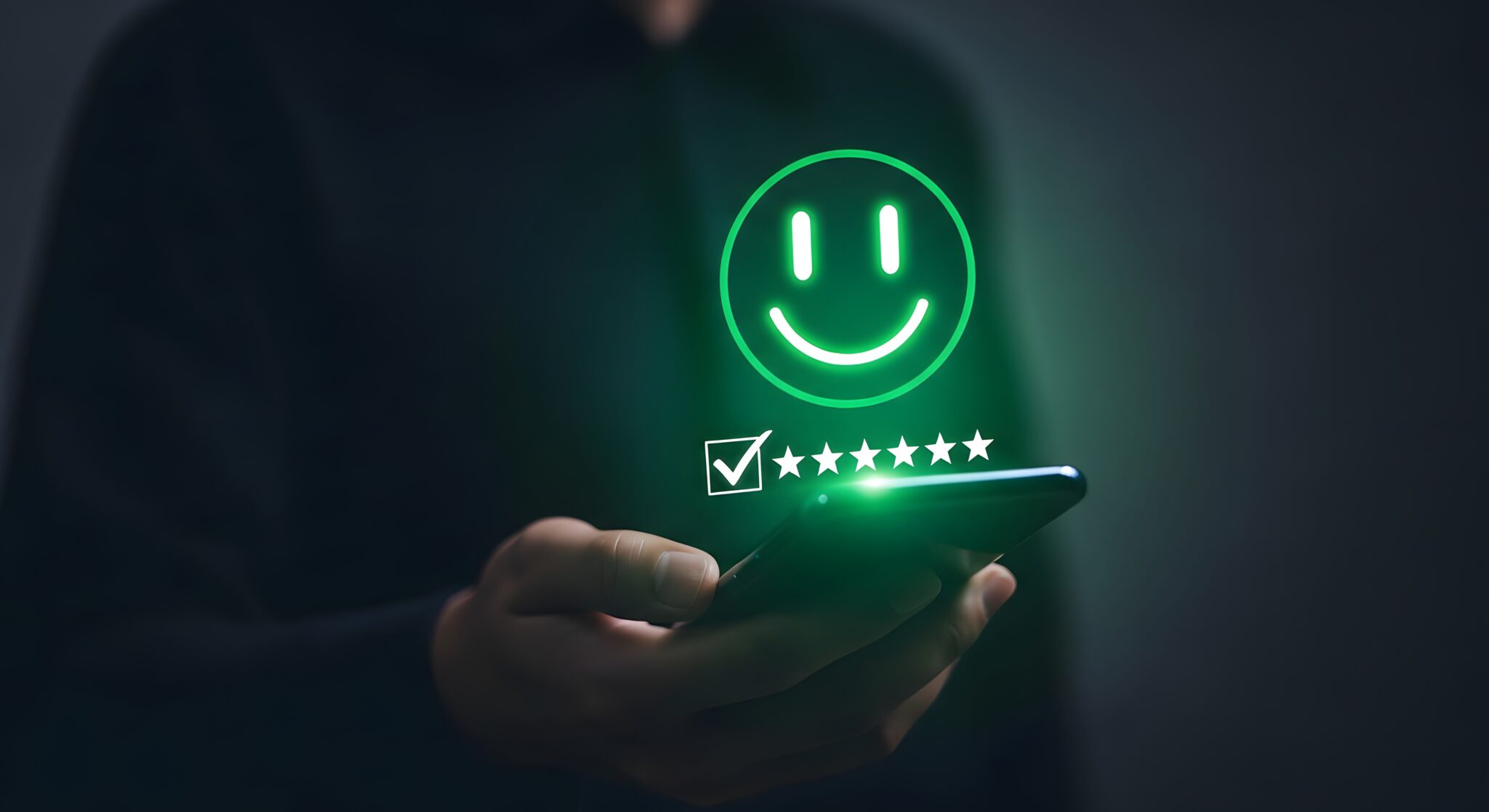 a person holding a phone with a green smiley face and checkmarks on the screen